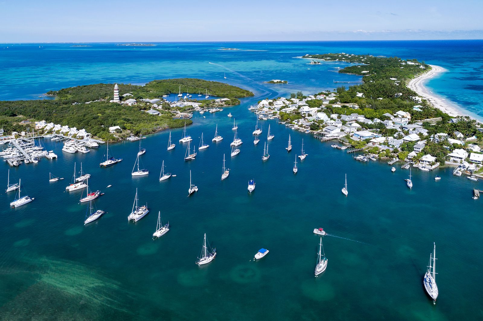 Aerial view showcasing various boats floating on the water, highlighting their arrangement and the surrounding aquatic environment.