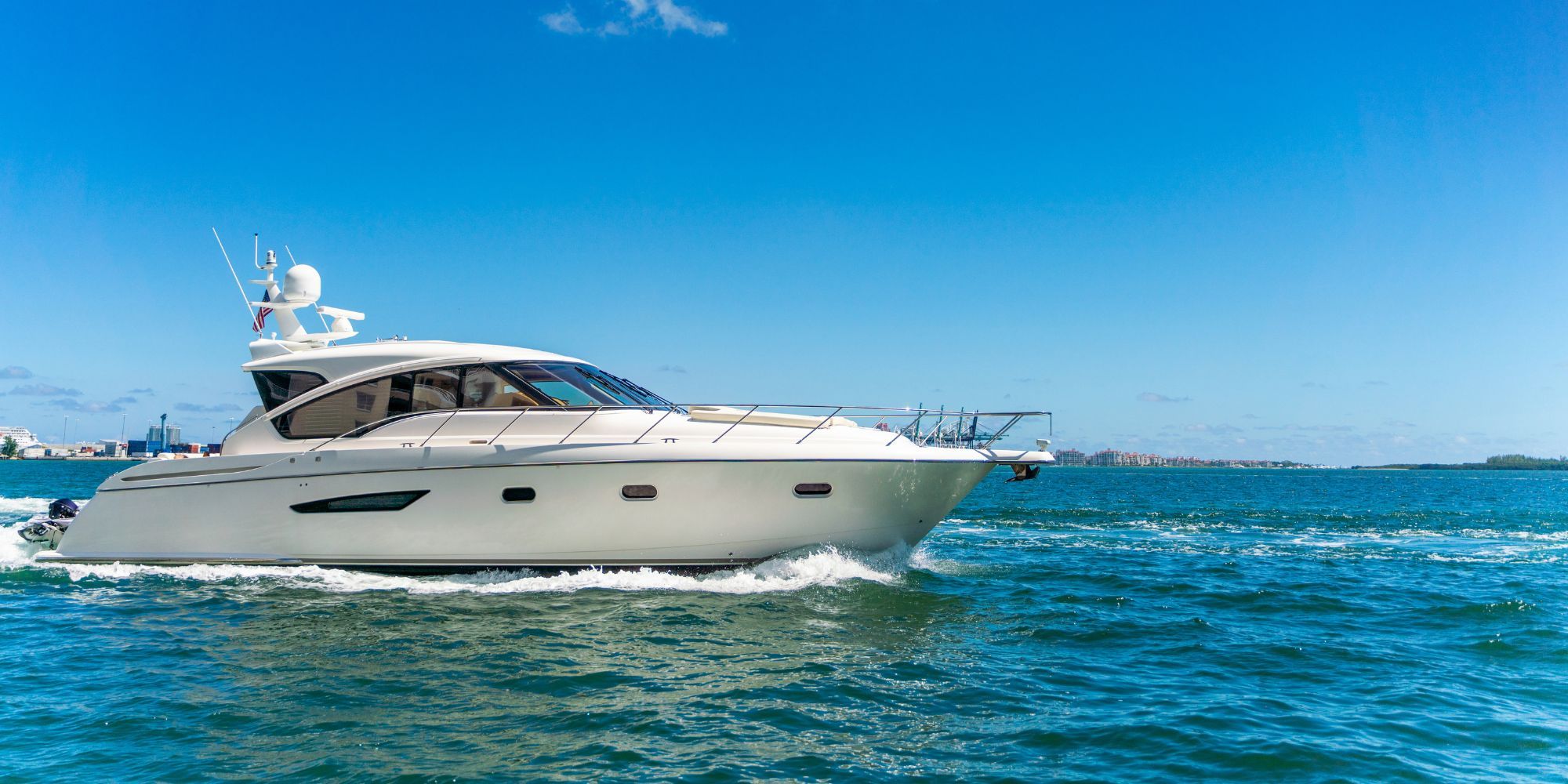 A motorboat gliding smoothly across the water, leaving a gentle wake behind it.