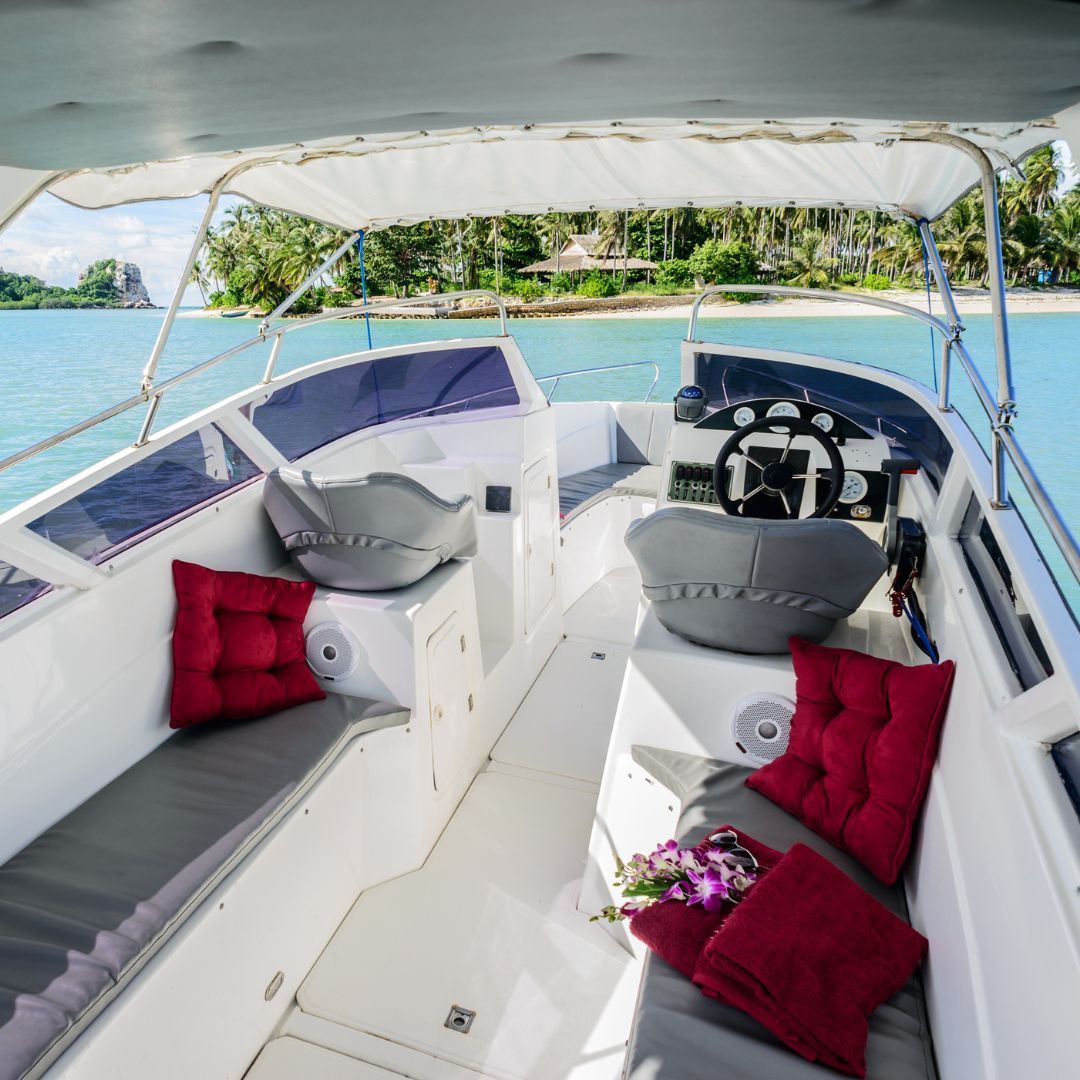 A cozy boat interior featuring plush cushions and pillows, creating a comfortable and inviting atmosphere.