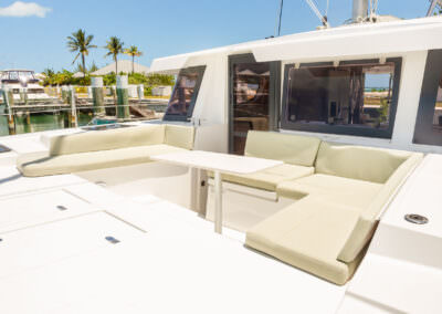 Interior view of a white boat featuring a comfortable couch, showcasing a clean and inviting nautical atmosphere.