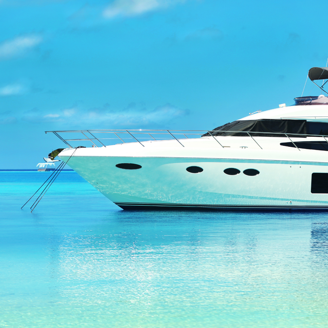 A white boat gently floats on calm water, reflecting the serene surroundings.
