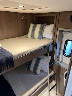 A view of small bunk beds inside a boat, showcasing their compact size and limited space for sleeping.