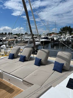 A cozy boat deck adorned with cushions and pillows, inviting relaxation under the open sky.