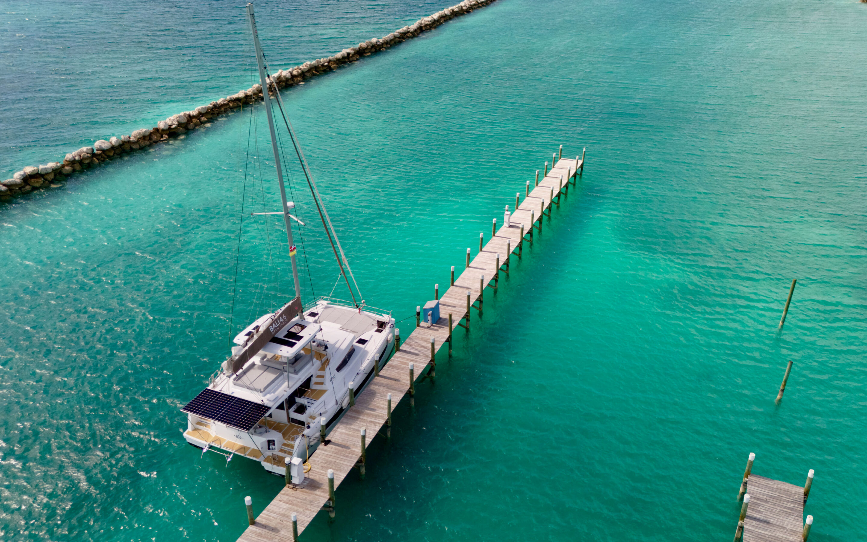 A boat is securely docked at a marina, surrounded by the tranquil waters of the ocean.