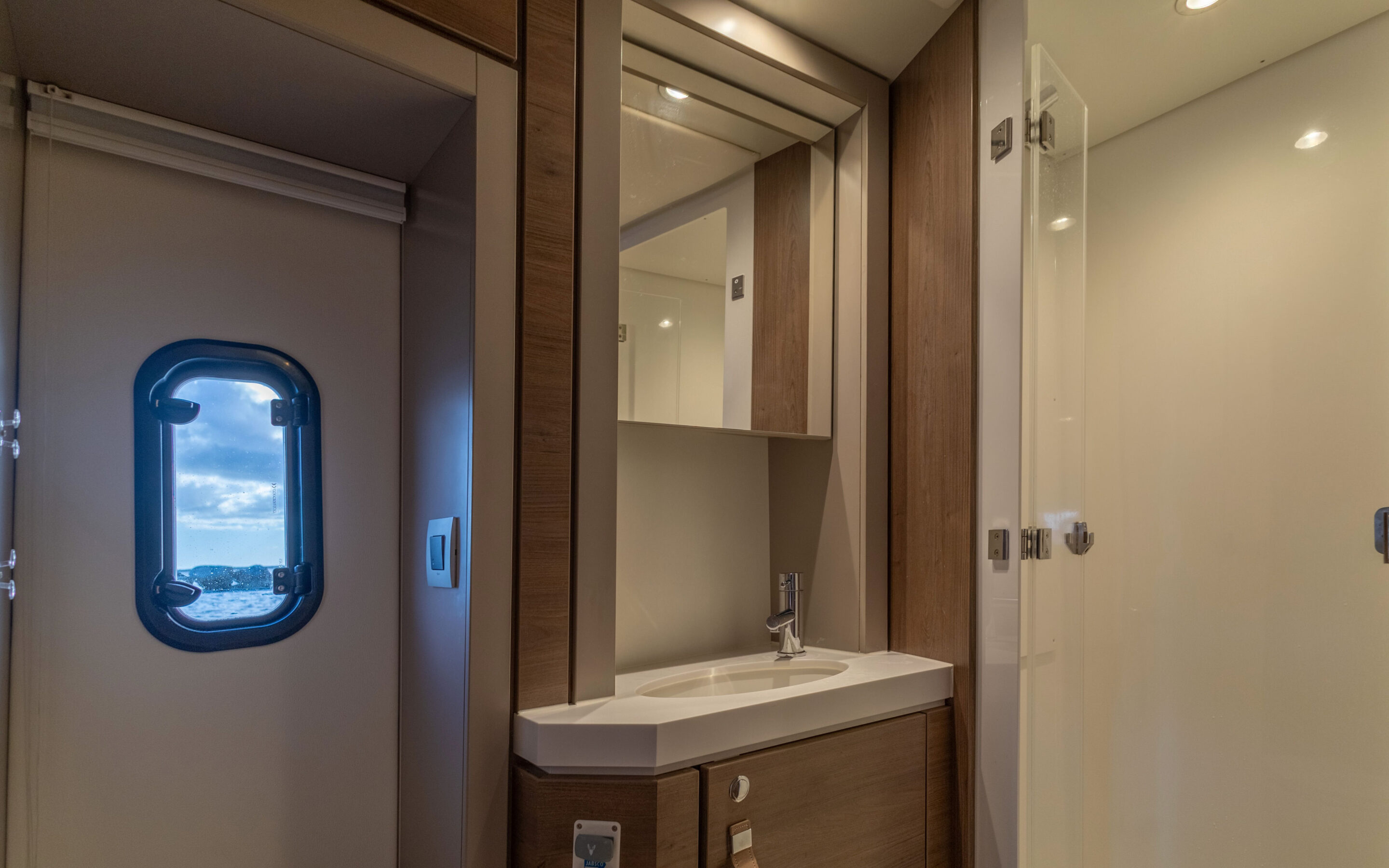 A clean bathroom featuring a sink, toilet, and shower, designed for functionality and comfort.