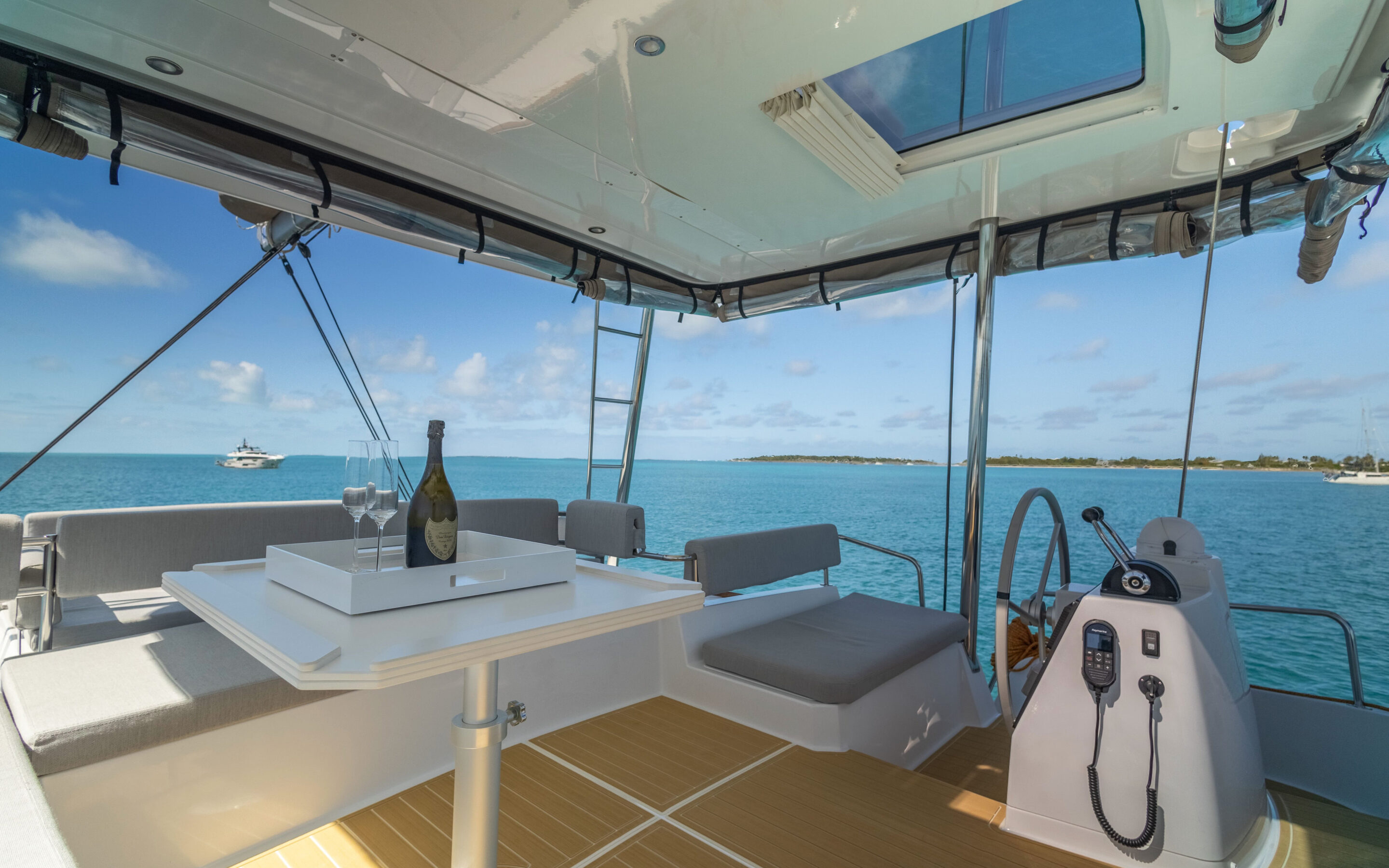 Interior view of a catamaran featuring a table and chairs, showcasing a cozy and inviting space for relaxation.