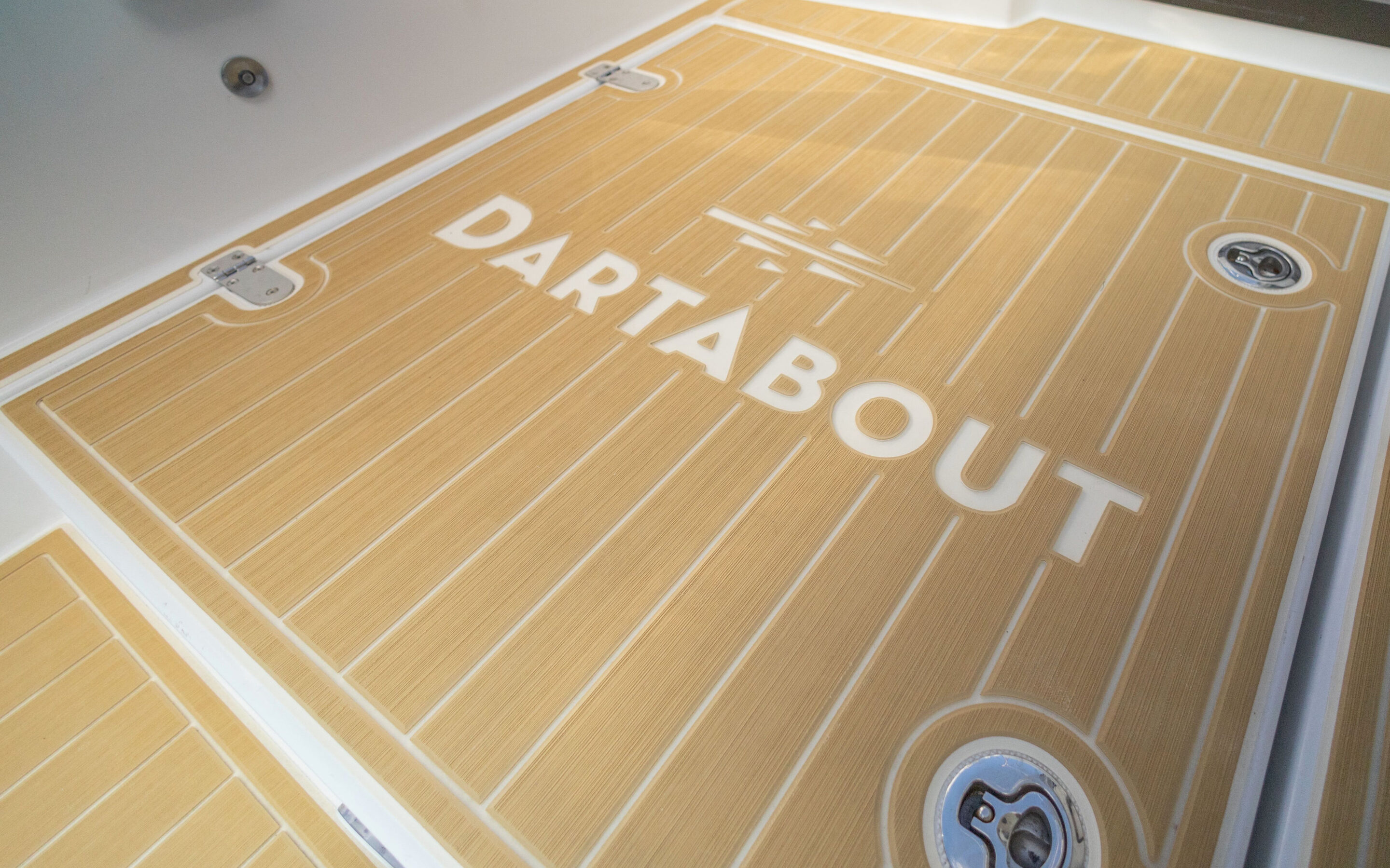 The floor of a boat featuring the word "Dartabout" prominently displayed on its surface.