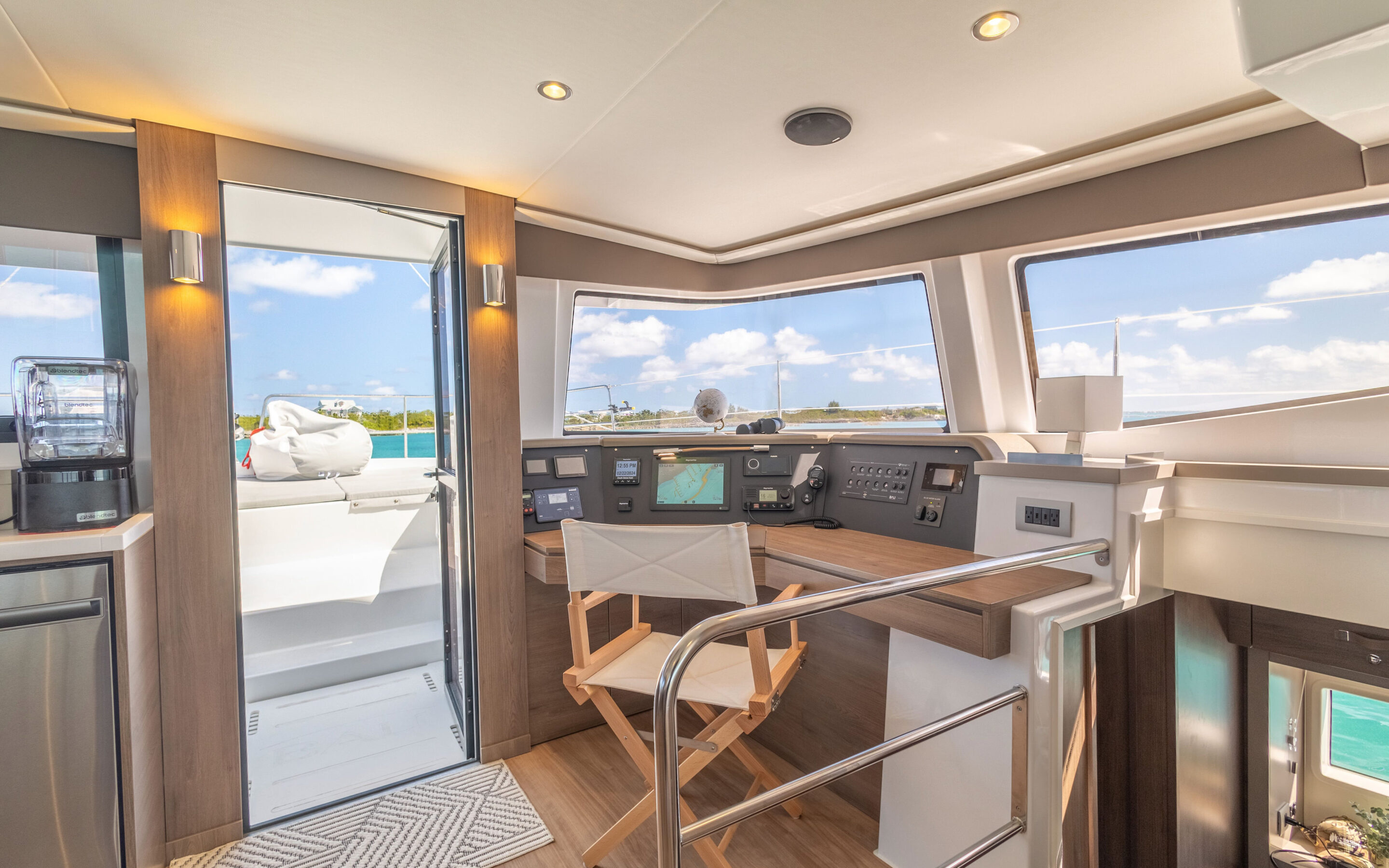 Interior view of a boat featuring a kitchen area and a desk, showcasing a compact and functional living space.
