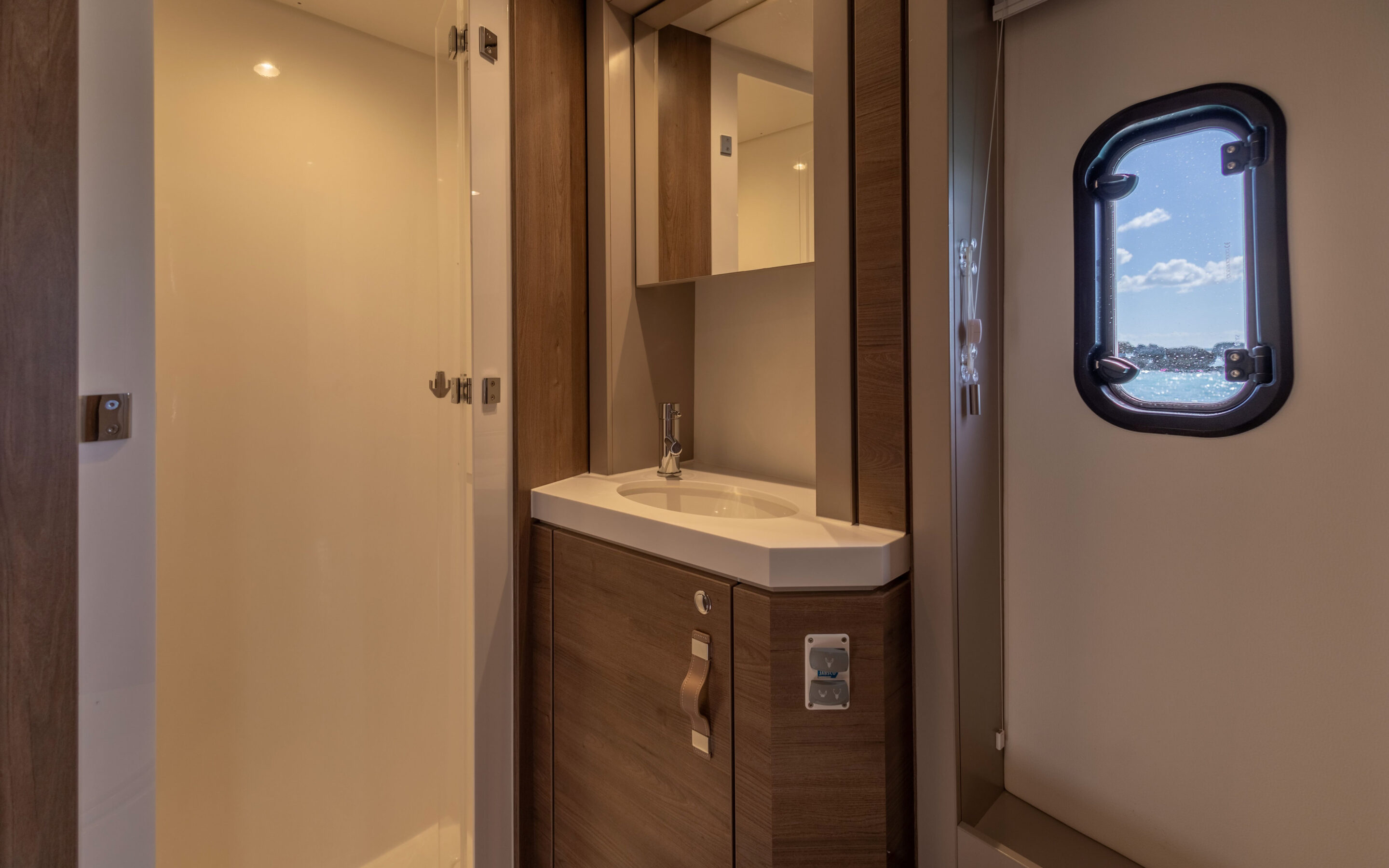 A bathroom featuring a sink, toilet, and shower, showcasing a clean and functional design.