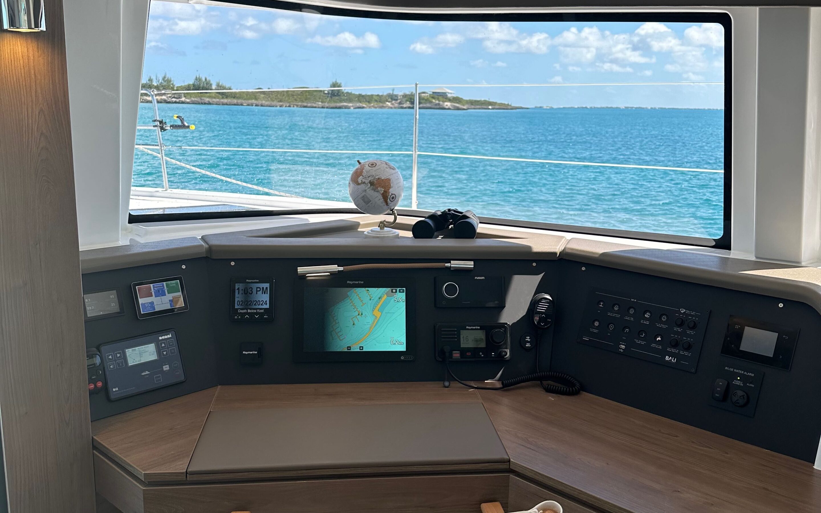 The interior of a boat featuring a spacious layout and a large screen for entertainment or navigation purposes.