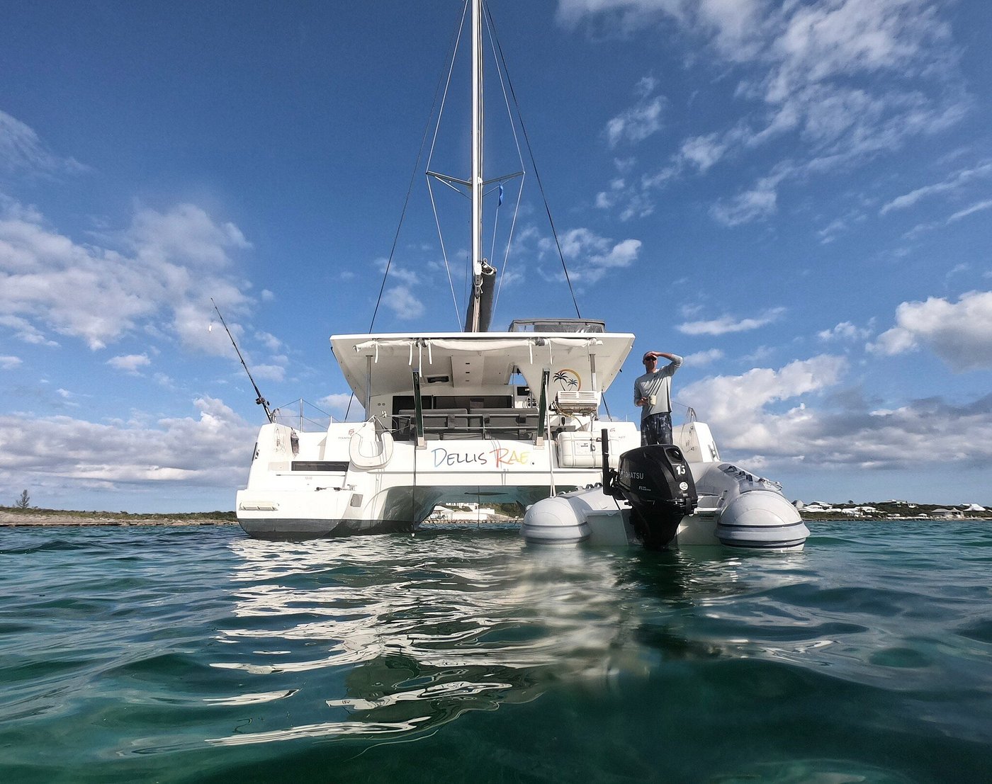 A catamaran anchored peacefully in calm waters, surrounded by a serene landscape.