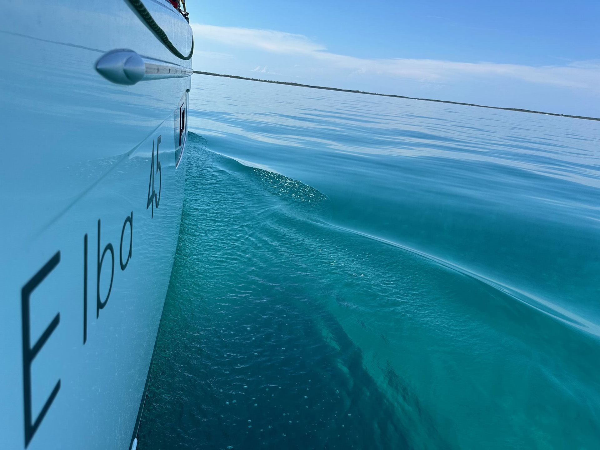 The bow of a boat cutting through the ocean.