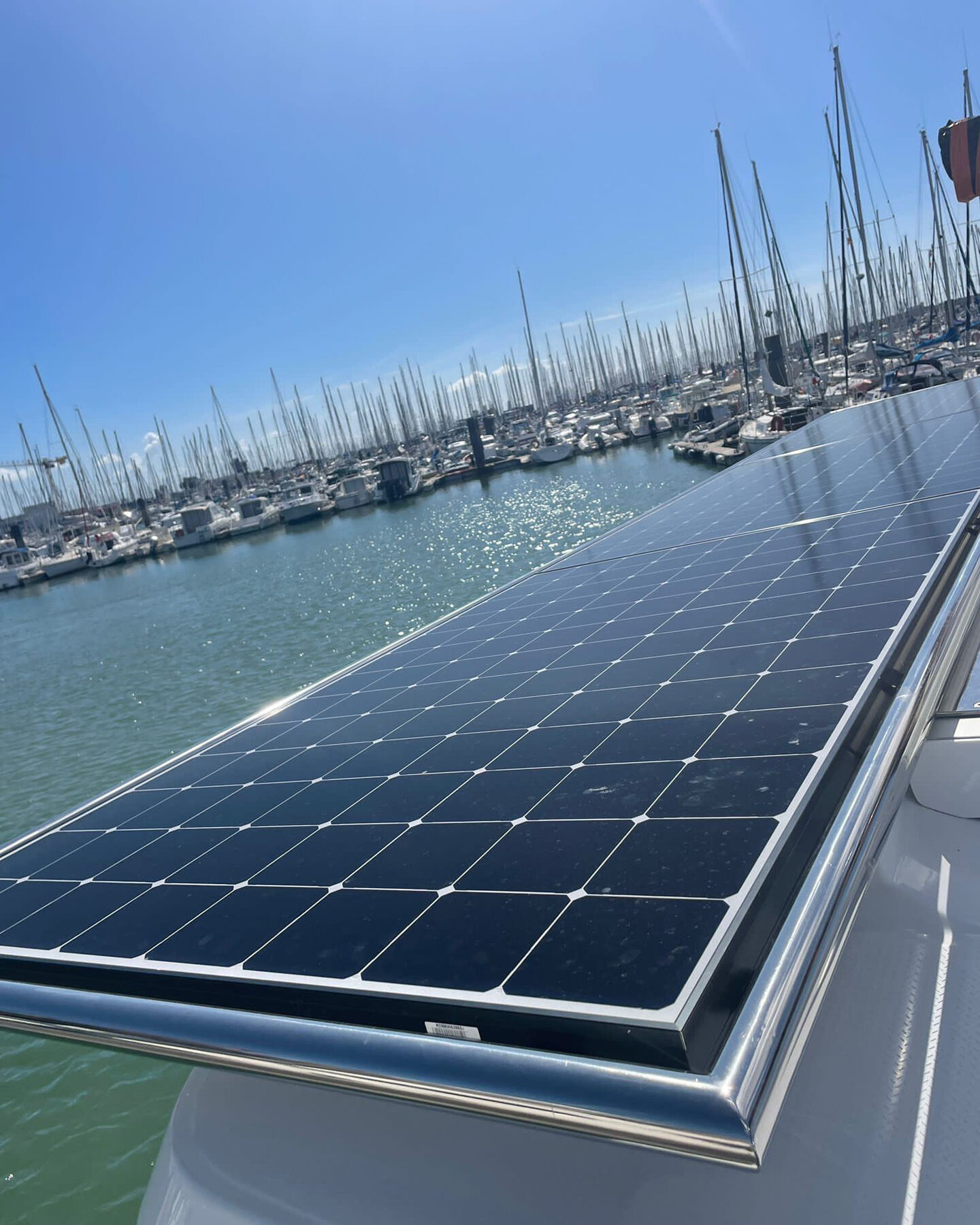 Solar panels installed on a boat's roof, floating on calm water, harnessing renewable energy for sustainable travel.