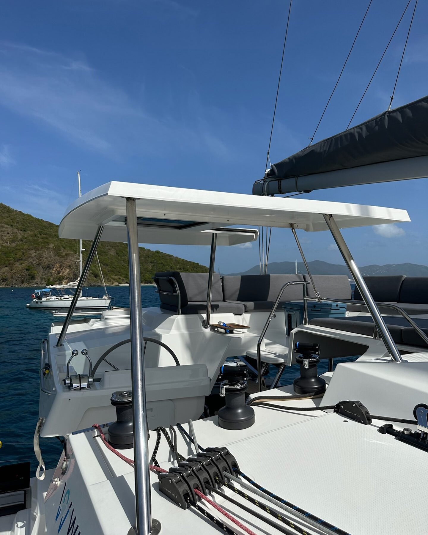 A white boat gently floats on calm waters, reflecting the serene surroundings in a peaceful setting.