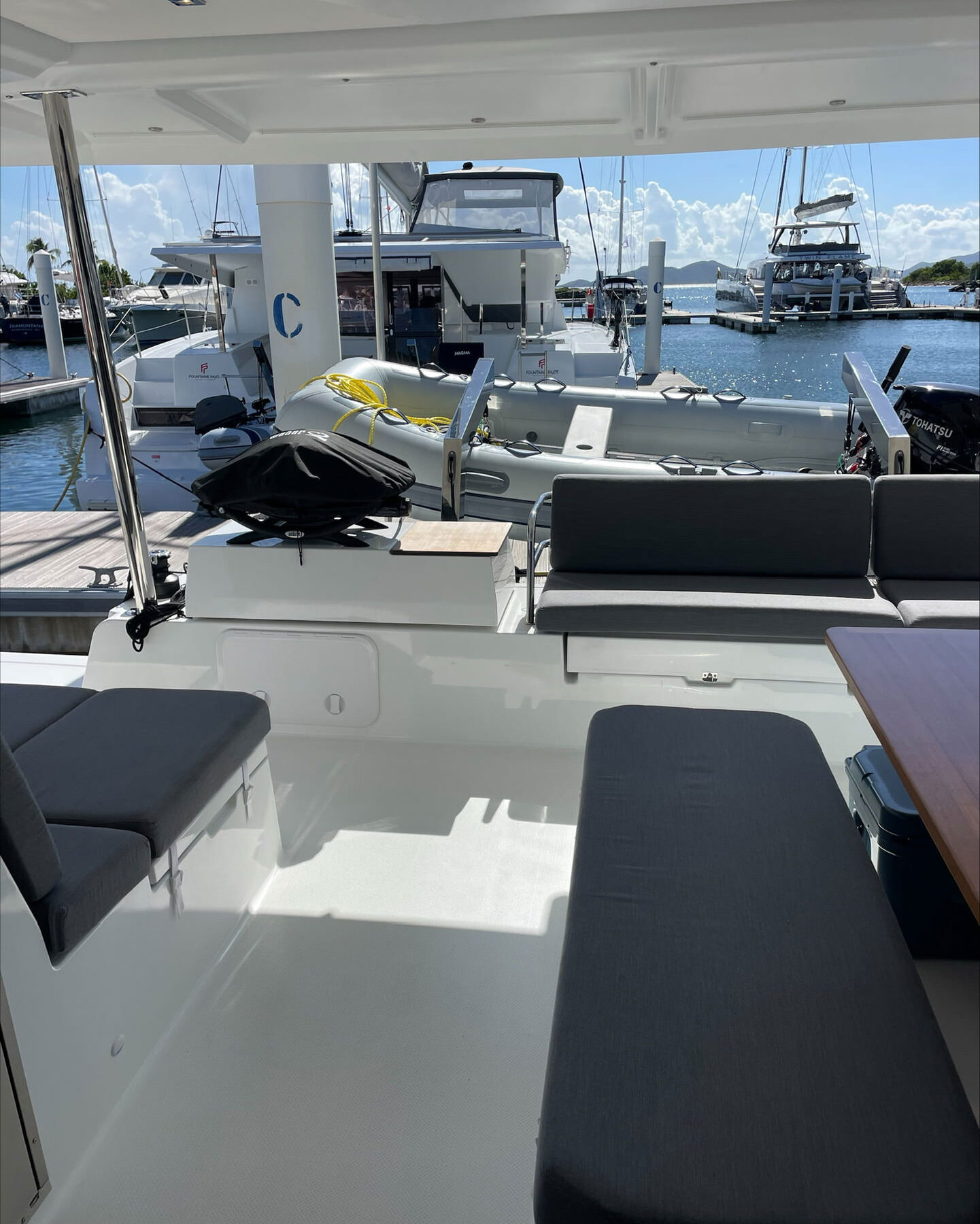 Interior view of a catamaran featuring a table and chairs, showcasing a cozy and inviting nautical atmosphere.