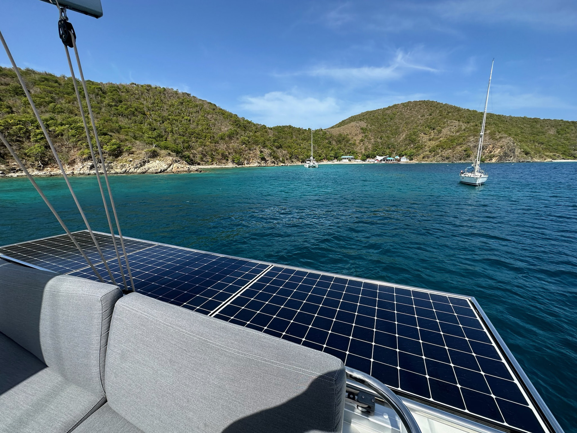 Solar panels installed on a boat's deck, floating on the ocean, harnessing renewable energy from the sun.