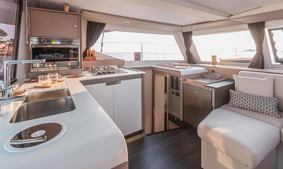 Interior view of a boat featuring a cozy kitchen and living area, showcasing a blend of functionality and comfort.