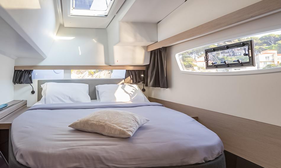 A cozy small room featuring a bed and a large window, creating a comfortable and functional space.