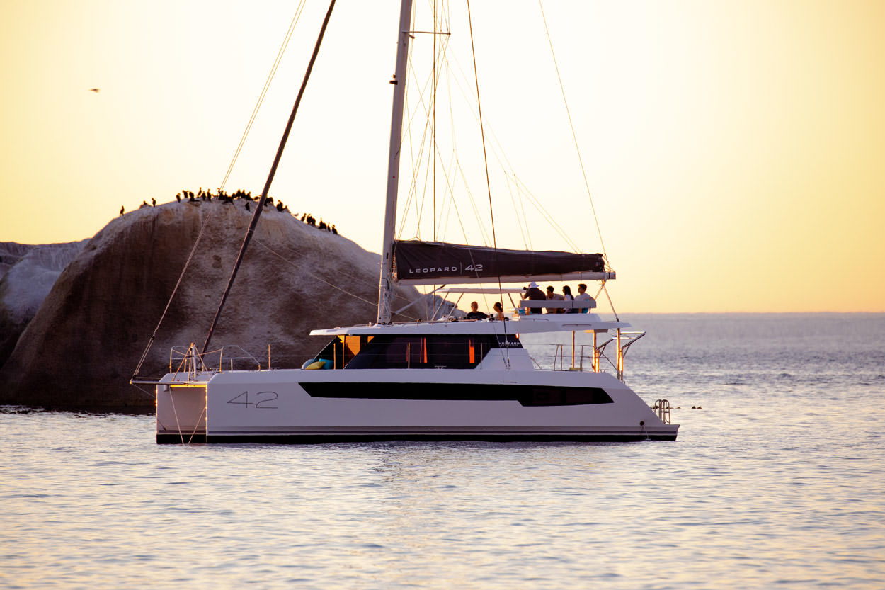 Serenity – Exterior 03 A serene boat floating gently on calm water, reflecting the surrounding landscape.