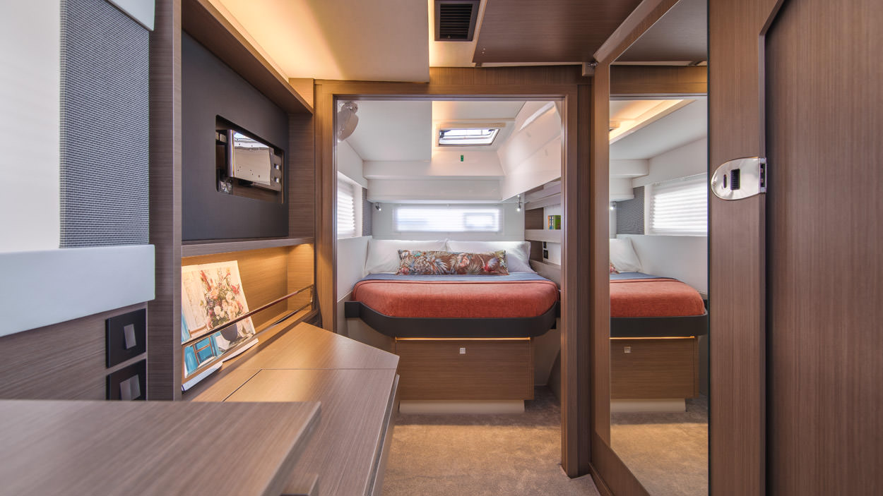 Serenity – Interior 01 A cozy bedroom featuring a neatly made bed and a desk, creating a comfortable and functional living space.