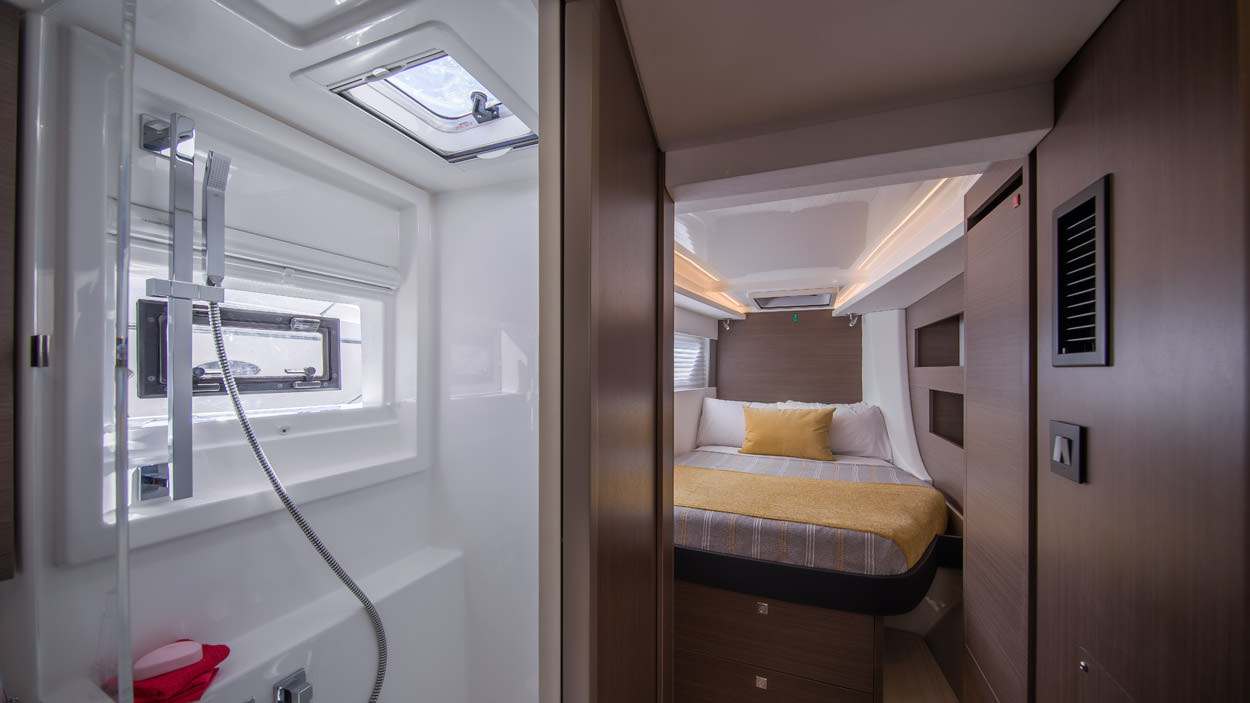 Serenity – Interior 04 A compact bedroom featuring a shower, showcasing a blend of comfort and functionality in a limited space.