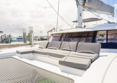 An open sun deck on a catamaran, inviting relaxation and enjoyment under the bright sun and clear blue skies.