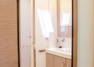 A minimalist bathroom with a polished sink and an elegant mirror, creating a serene and functional atmosphere.