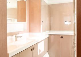 A pristine bathroom featuring a spotless sink and toilet, showcasing cleanliness and orderliness in the space.