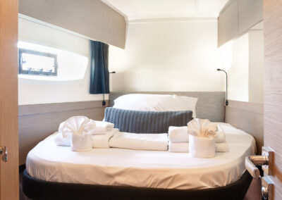 A compact bedroom showcasing a bed adjacent to a door, emphasizing simplicity and functionality.