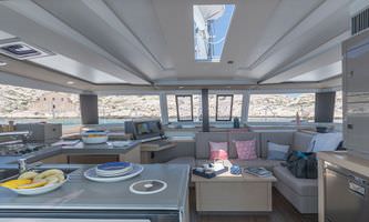 Interior view of a boat featuring a cozy kitchen and living area, showcasing a functional and inviting space.