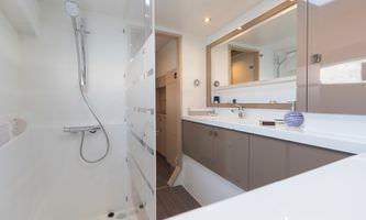 A clean bathroom featuring a shower, sink, and toilet, designed for functionality and comfort.
