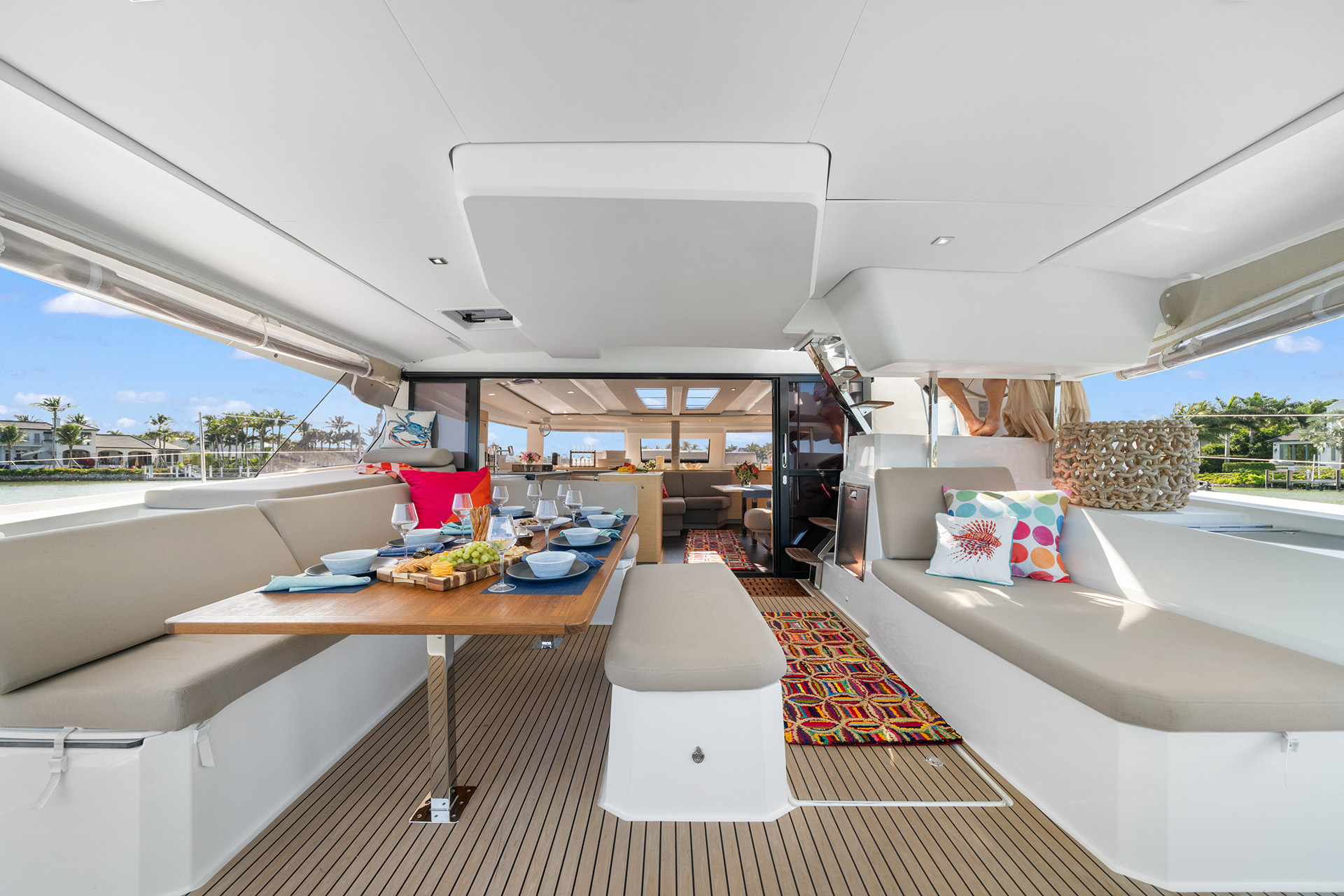 Interior view of a boat featuring a dining table surrounded by chairs, showcasing a cozy and inviting atmosphere.
