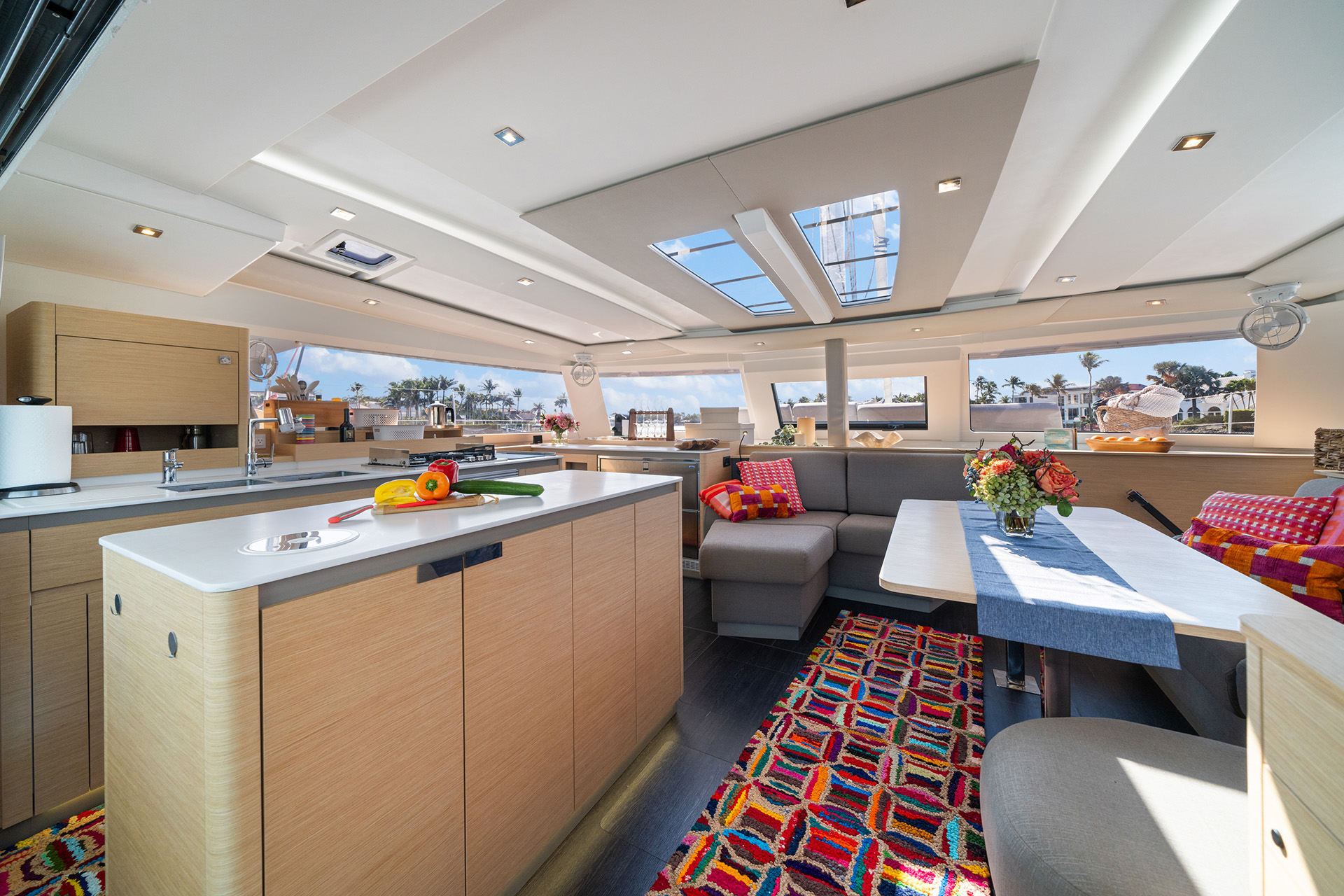 Interior view of a boat featuring a cozy kitchen and dining area, showcasing functional design and nautical decor.