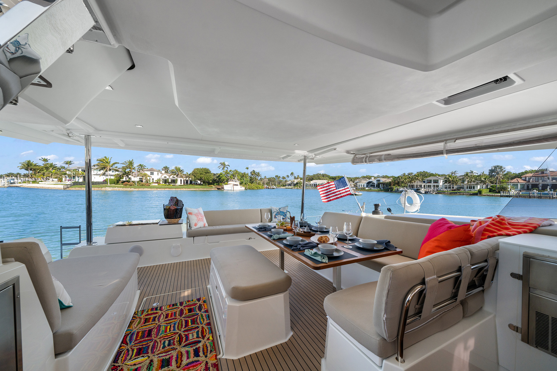 A boat's interior displaying a dining area with a table and chairs, designed for comfort and social gatherings.