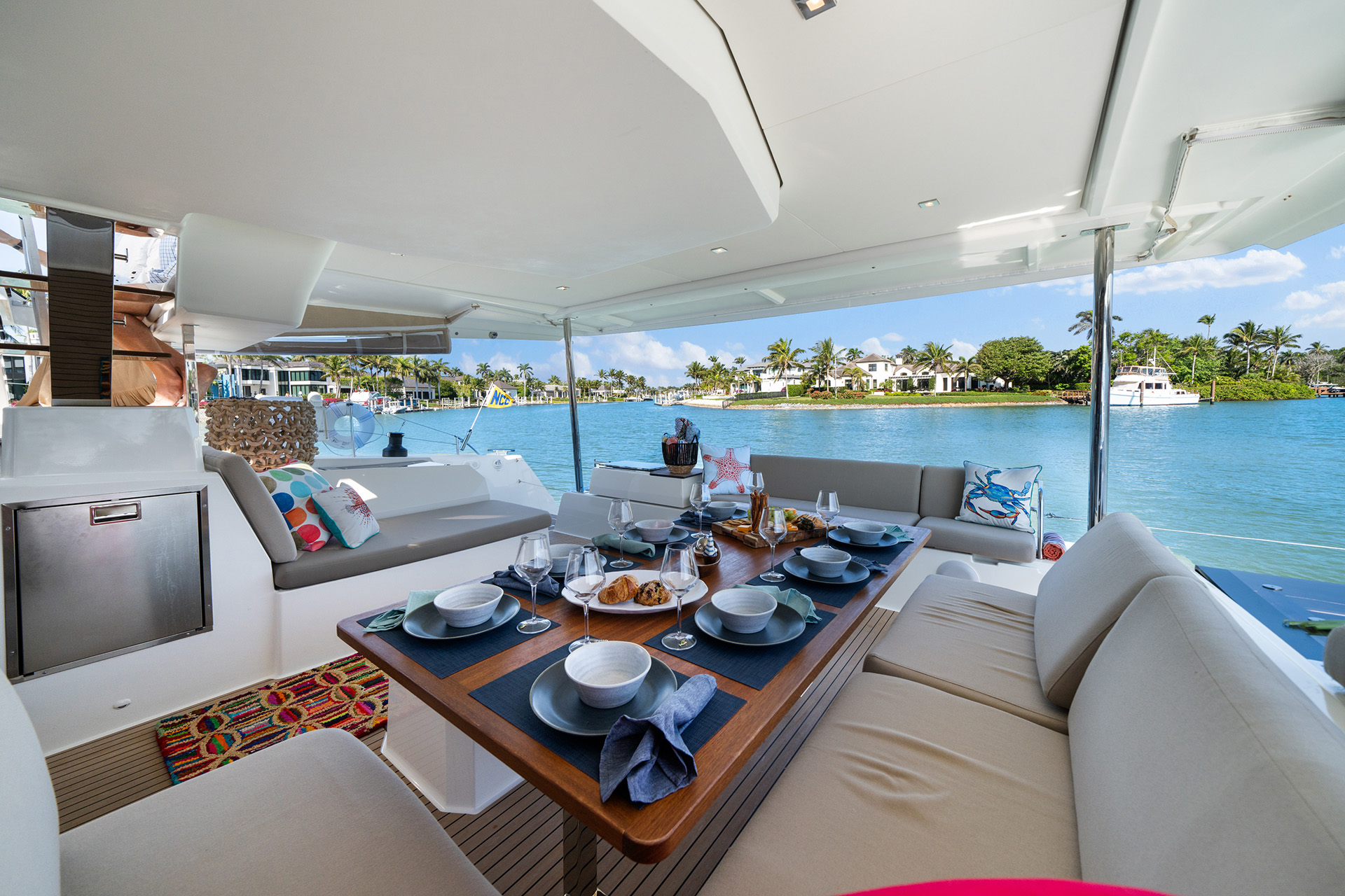 A luxurious yacht living area featuring a stylish dining table surrounded by elegant chairs, exuding comfort and sophistication.