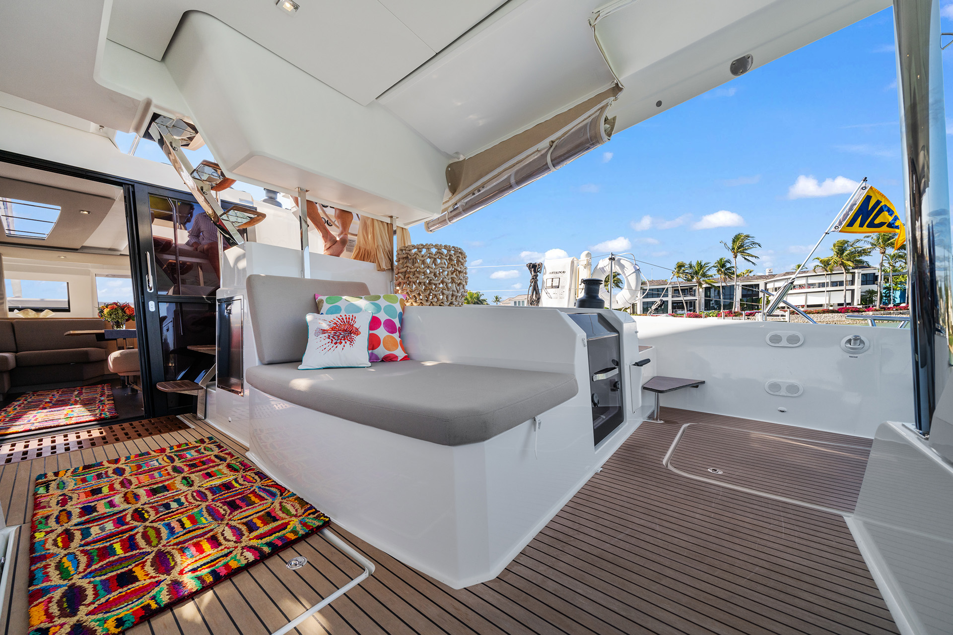 A cozy boat interior featuring a comfortable couch and a stylish rug, creating a welcoming atmosphere.