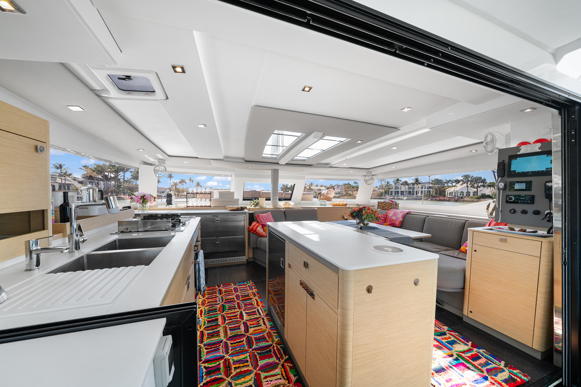Interior view of a boat showcasing a stylish kitchen and living room, designed for comfort and maritime living.