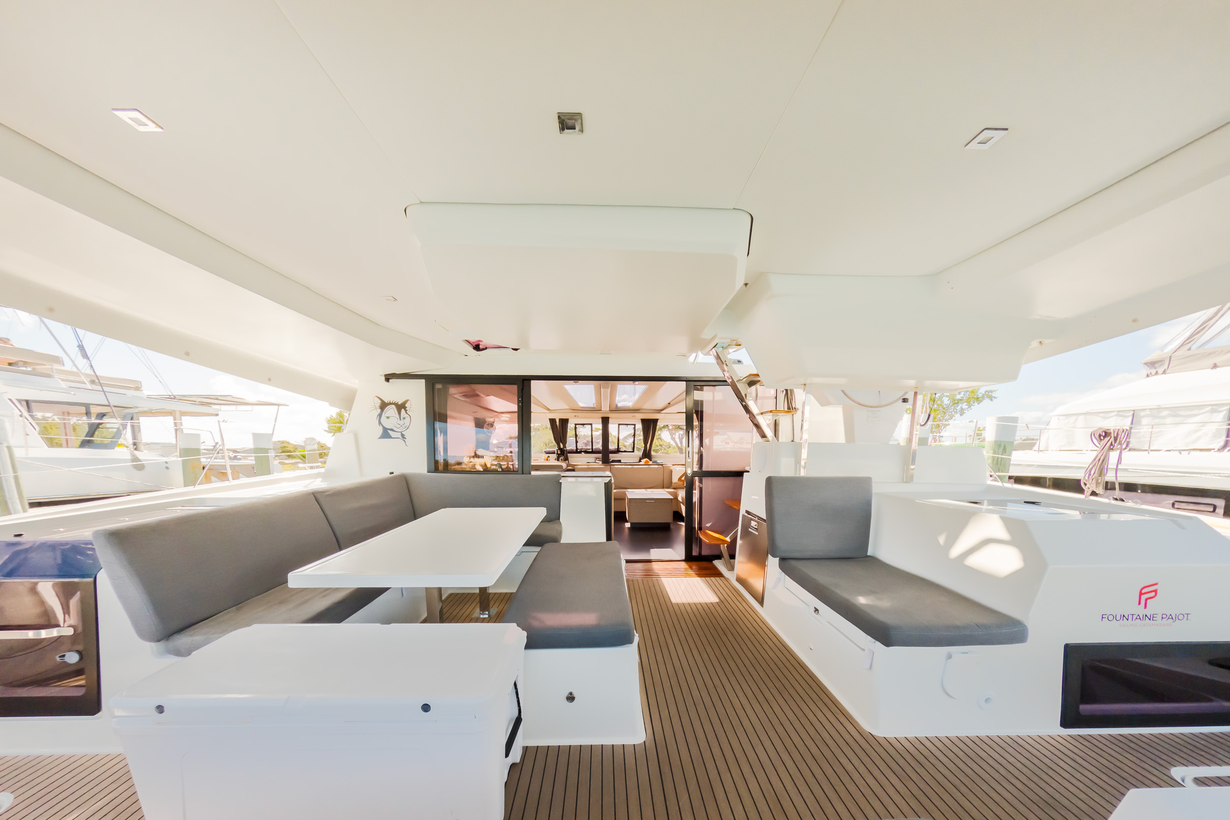 Interior view of a boat featuring a table surrounded by chairs, showcasing a cozy dining area