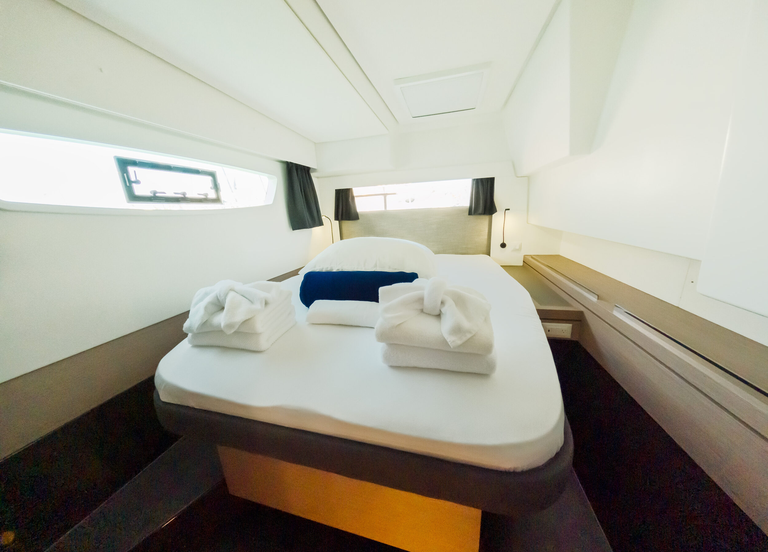 A small room featuring a bed positioned near a window, allowing natural light to enter the space.