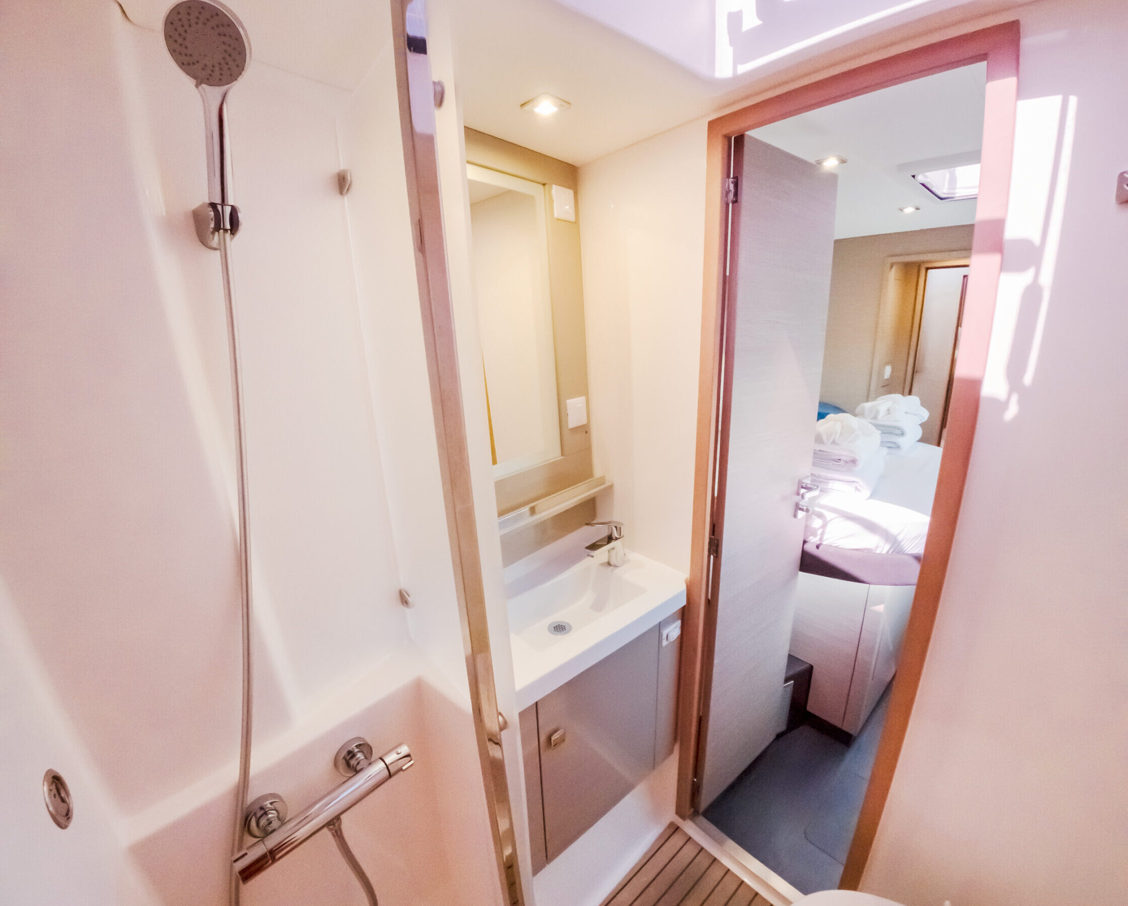 A compact bathroom featuring a small shower, emphasizing its limited space and functionality.