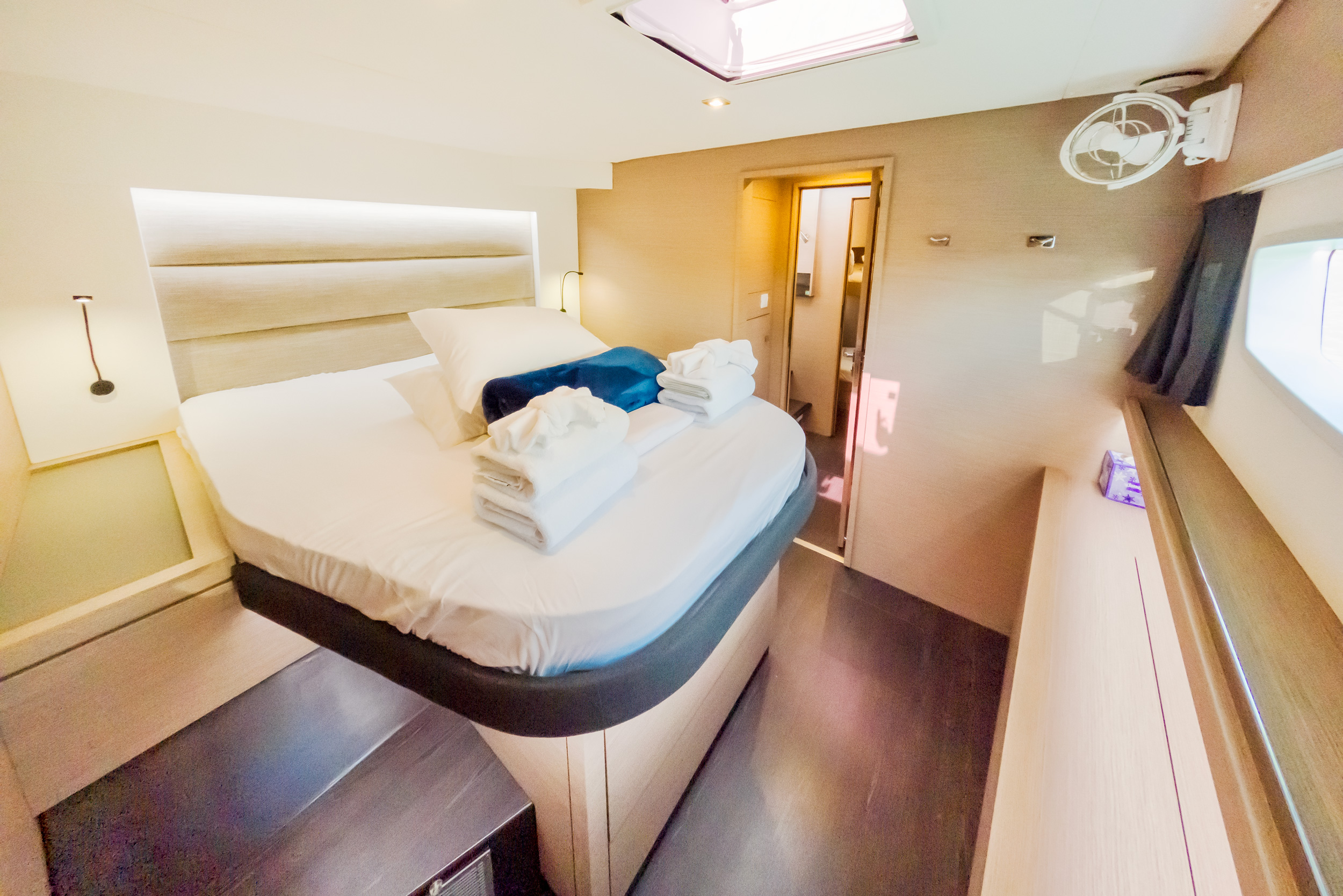 A small room featuring a bed positioned near a window, allowing natural light to enter the space.