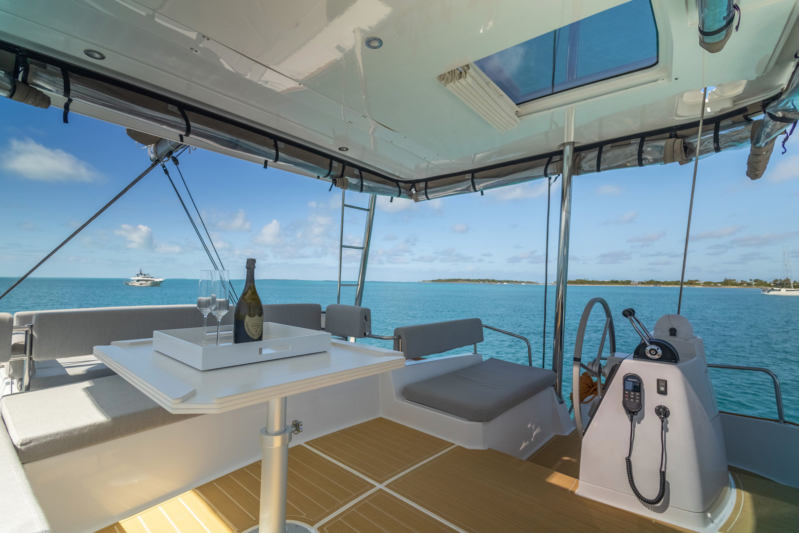 Interior of a catamaran featuring a table surrounded by chairs, showcasing a cozy and functional dining area.