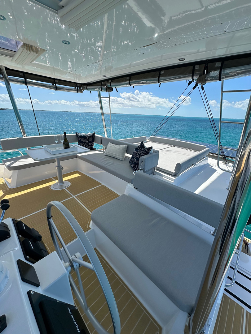 Interior view of a spacious catamaran featuring a large deck and comfortable seating areas for relaxation.