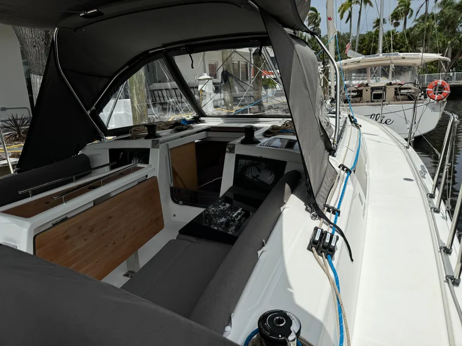 Interior view of a boat featuring a large control console and seating area, showcasing nautical design elements.