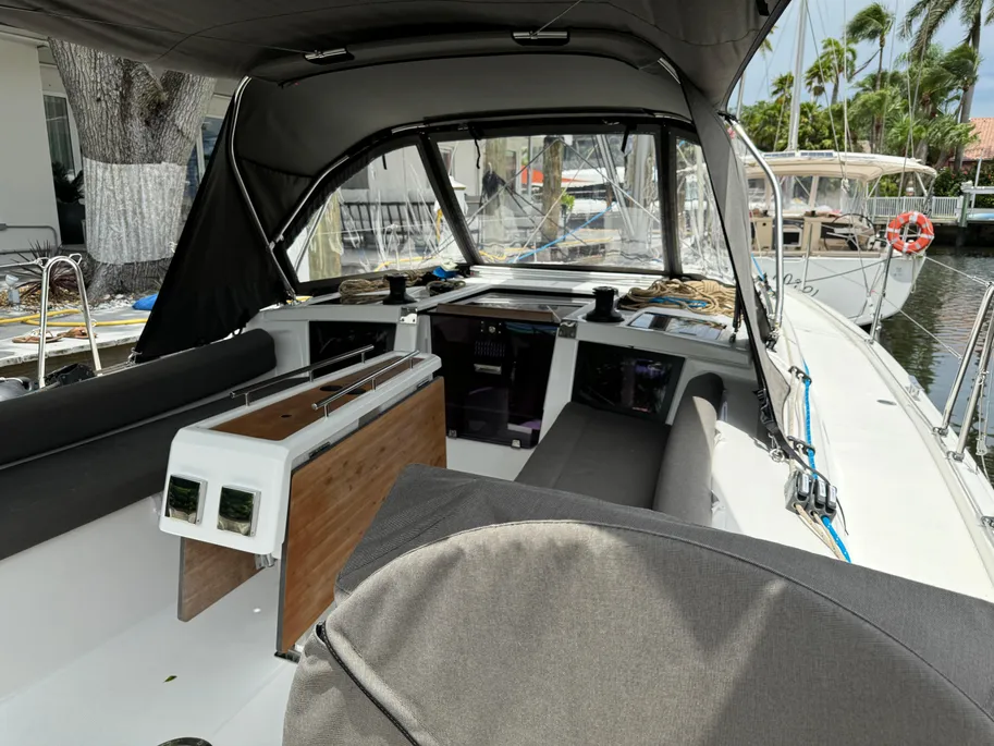Inside a boat, highlighting a spacious console with controls and seating, emphasizing the vessel's functionality.