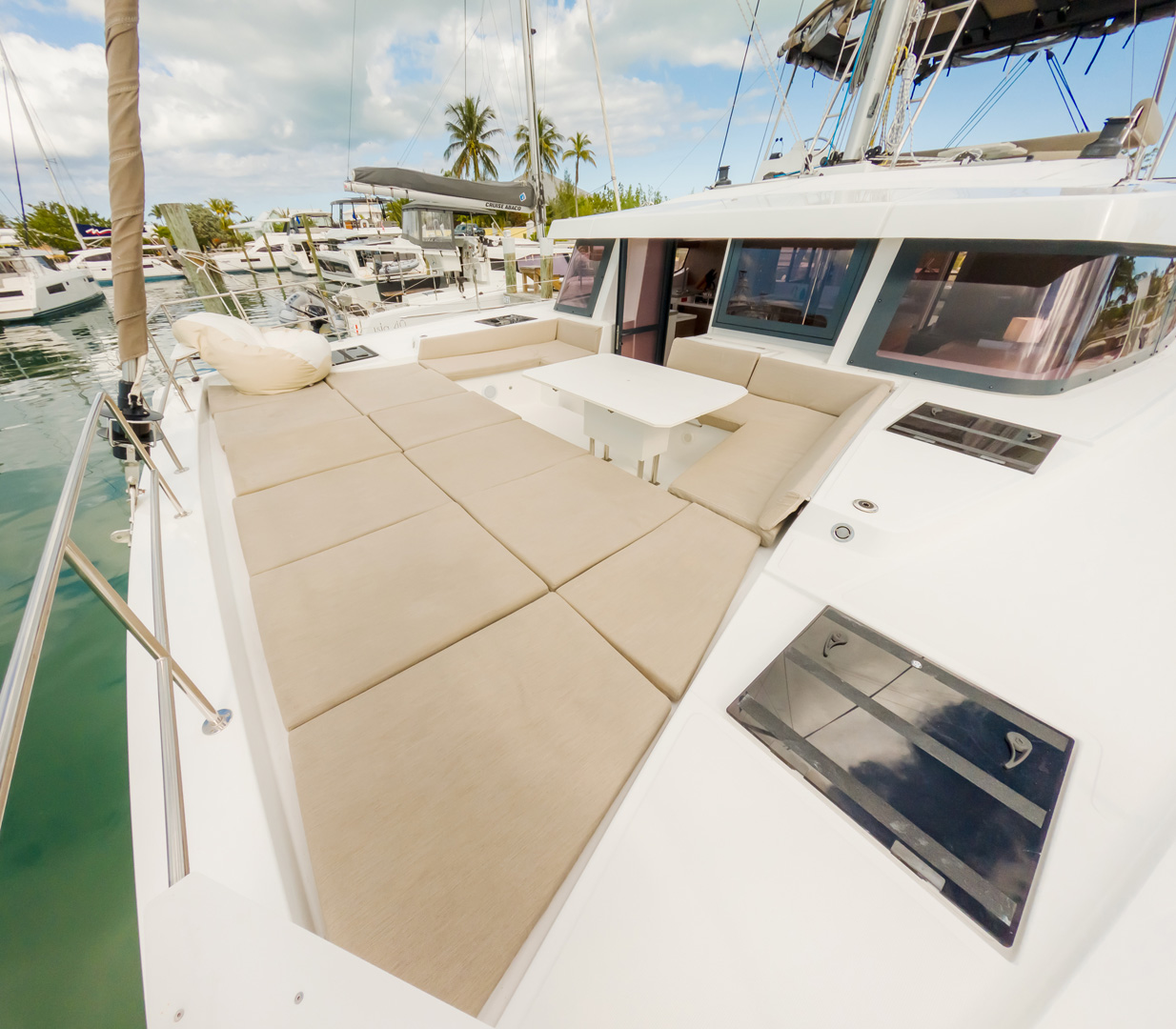 Interior of a catamaran featuring a cozy couch and a table, designed for relaxation and socializing on the water.
