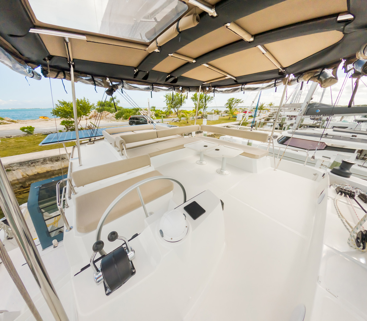 Interior view of a catamaran featuring a spacious sun deck, showcasing comfortable seating and nautical decor.