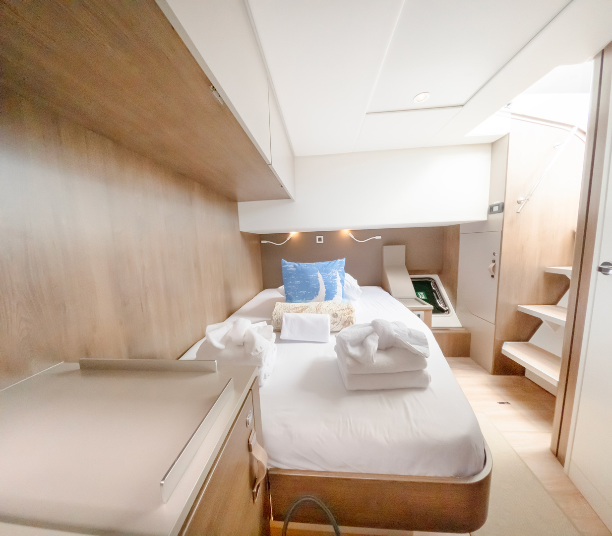 A small bed with a bedside table in a cozy, compact room.