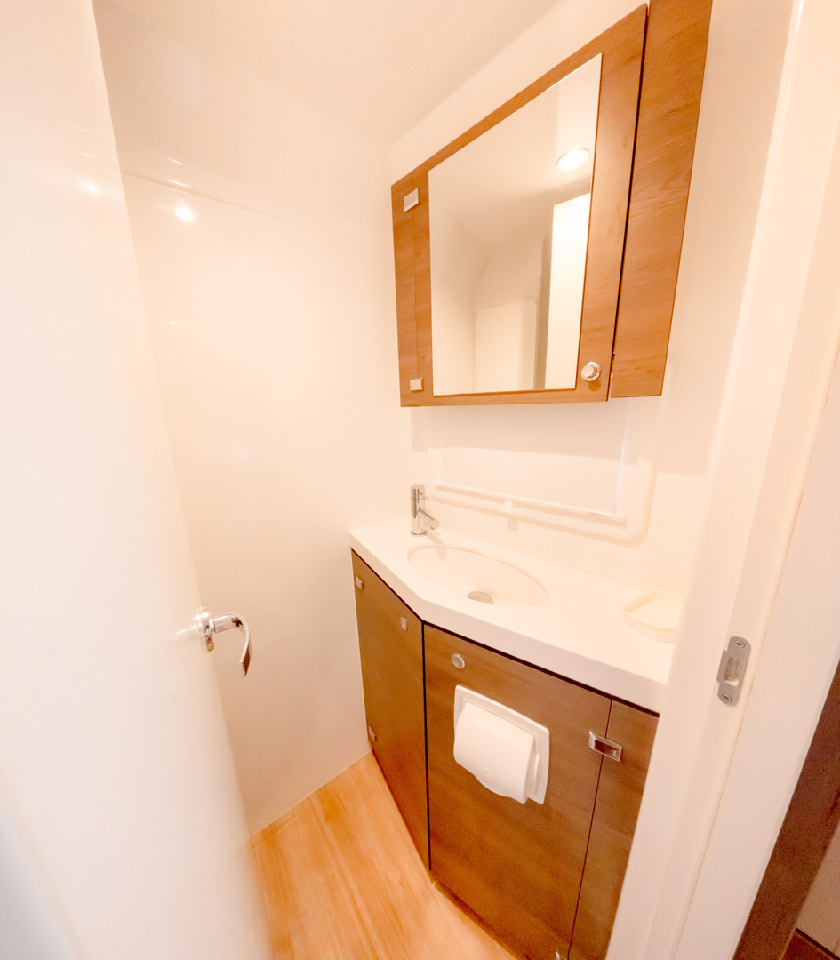 A bathroom featuring a sink and a mirror above it, with neutral-colored walls and a clean, modern design.