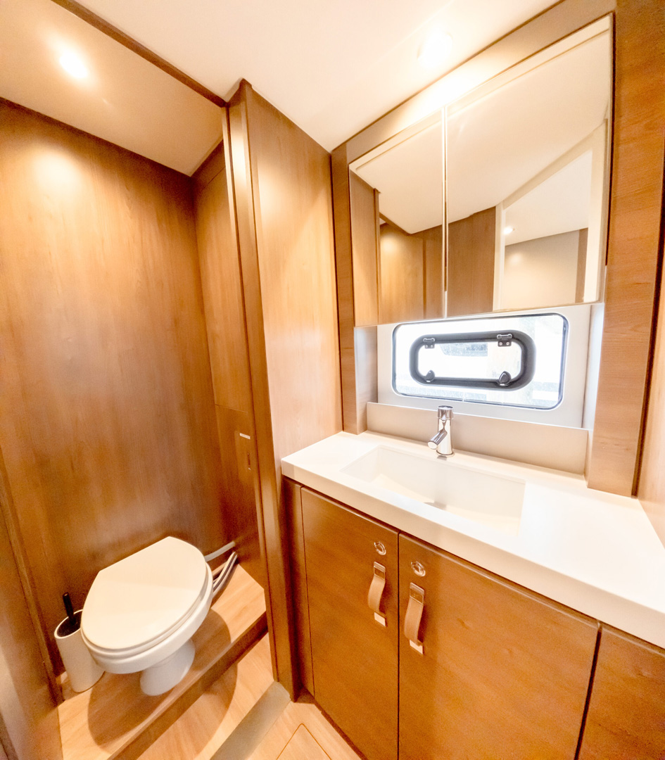 A clean bathroom featuring a white toilet and a modern sink against a neutral wall.